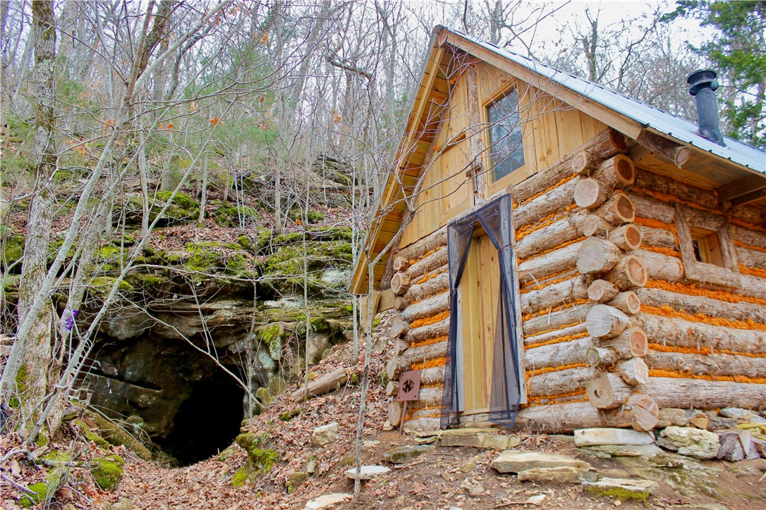 Tucked away in the scenic Ozark Mountains, this surveyed 30+/-acre property offers a unique blend of adventure, natural beauty, and seclusion. Featuring a cozy 200 sq. ft. off grid cabin, this land is an ideal getaway for nature lovers, hunters, and outdoor enthusiasts alike. One of its most captivating features is a multi-room cave system, providing a place to store foods and goods during times of unrest. Additionally, theres an improved spring providing a steady flow of fresh water, enhancing the propertyās self-sufficiency and charm. With breathtaking mountain views and a level build site, this land is primed for your dream home or off-grid retreat. Just 15 minutes from both the White River and Buffalo River, renowned for their fishing, floating, and outdoor recreation. Additionally, the charming town of Yellville, AR, is only 7 miles away, providing easy access to dining, shopping, and necessities.