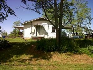 Good location near Woodland. This property has a detached shop, nice trees, a paved road, city water and three wells. Over 300 sq. ft. of covered porches.