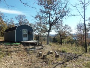 Property borders Bull Shoals Lake corp line on 3 sides. Pretty view of lake. Also includes a 12' x 28' cabin/bldg. Cabin is wired, insulated & has a window a/c. Nice get-away place or build your dream home. Land has been surveyed.