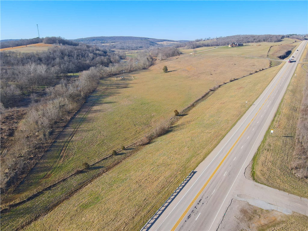 Donāt miss your chance to explore this stunning 25.5-acre property, which boasts highway
frontage on two sides. Zoned as DUZ (dual use zone), it allows for either C-2 or R-1
development. This site is ideal for commercial development, offering direct access to Hwy 412
and Hwy 23, or as a future home location in the rapidly growing area of Huntsville, AR. With
city water, sewer, electricity, and fiber readily available, utility setup is straightforward. Holman
Creek flows along the eastern edge of the property, providing a picturesque environment and
recreational possibilities. The property enjoys excellent visibility from both highways,
presenting significant commercial potential. According to the Arkansas Department of
Transportation, the traffic count at this intersection exceeds 11,000 vehicles daily. With custom
homes being built nearby, the desirability of this location is evident. Whether for commercial
or residential use, this area is showing substantial population growth.