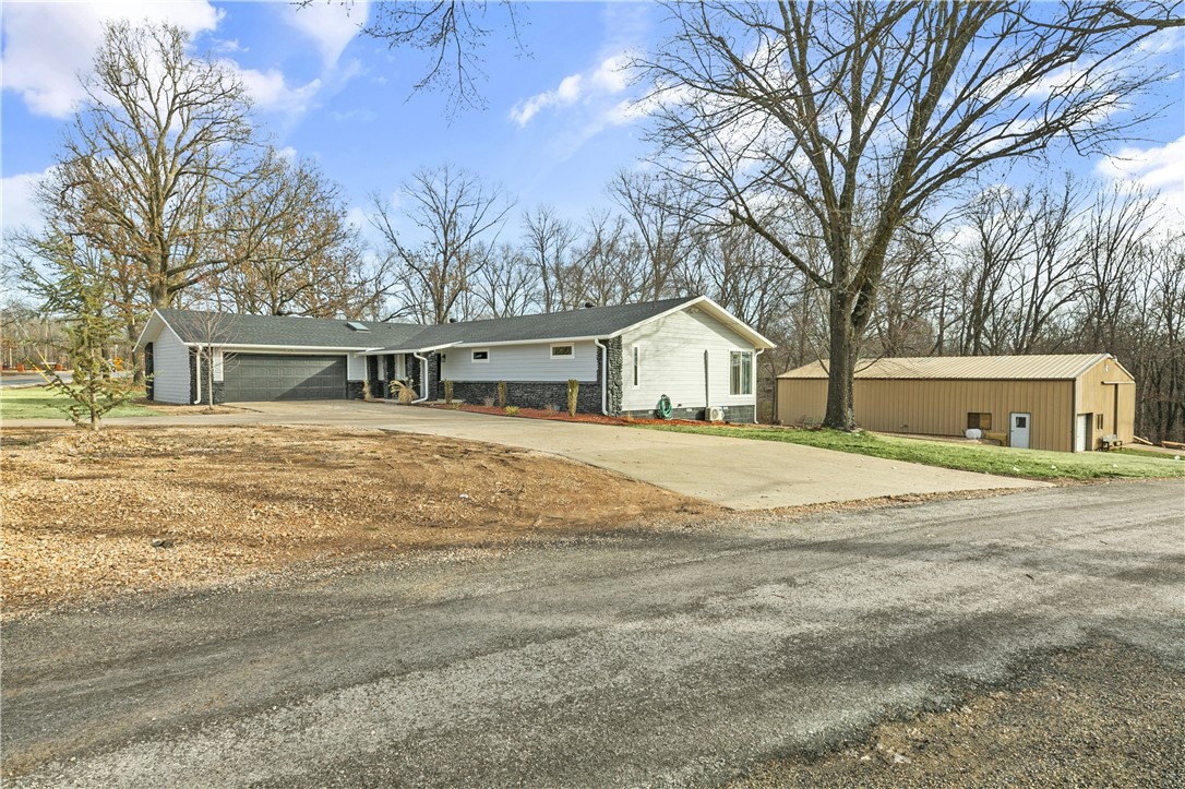 Welcome to your next home! Complete transformation from its original 1980's style. Want peace and quiet but close to everything? LOOK NO MORE! So much space and extra large garage and shop for the car enthusiasts or wood workers. This home has it all for EVERYONE... 35*60 shop, would make a great indoor pickle ball court!! 3.65 acres to spread out on and a home that anyone would love. 5" white hickory wood floors throughout, Chefs kitchen, open concept with accent walls, modern and sleek and all right on the bike trails. Lets not forget the fur babies, underground invisible fence on 1 acre for them to roam. NOT POA, only city! Would make a great AIRBNB and can come completely furnished for an additional amount. Located between the BEST LAKES IN BV, Loch Lomond & Windsor and property backs up to the trailhead. Just 7 mins to the new bypass and into Bentonville in 15 mins. This is truly a rare gem in Bella Vista.