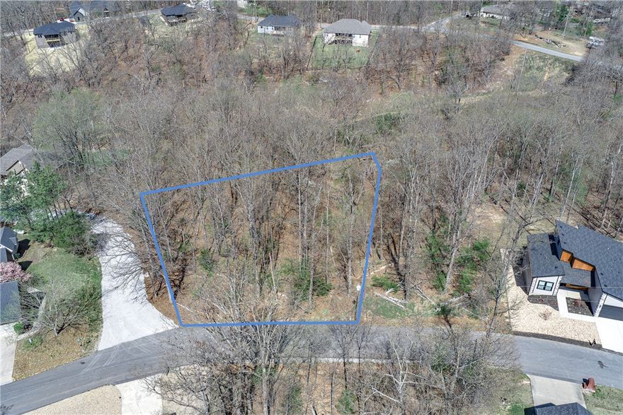 Here's your chance to build in one of NW Arkansas's most beloved communities! This beautiful 0.29-acre wooded lot sits on a gentle slope along Damerham Lane in Bella Vista's Hampshire subdivision, with the Rago mountain biking trail practically in your backyard — connecting you to over 110 miles of world-class trails. As a Bella Vista POA member, you'll enjoy access to 7 stunning lakes, 7 championship golf courses, multiple recreation centers, pools, tennis, and pickleball. Electric and public water are ready at the street, it's outside any flood zone, and annual taxes are just $99. No appointment needed — go take a look today!