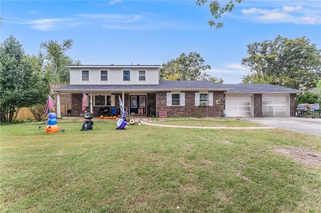Unique 2-story home on 2 acres in town! Nestled back off the road with mature shade trees and lots of room to move. The home features a living room and formal dining room, with the kitchen and breakfast area adjoining. 2nd living room/hearth room off kitchen with a sunroom along the back. Primary suite is downstairs and all other bedrooms, including a 2nd Primary Suite with deck overlooking the property, are upstairs. Oversized 2-car garage and workshop. Enjoy gardening, chickens and horses with a barn and garage/workshop and storage building. New roof on house and detached garage, new wood privacy fence, new gas line going to the house. If you are looking for a place to park an RV, this is it- with a gate that opens to the back, for an RV or truck to drive through. A unique property right in town. Come see!
