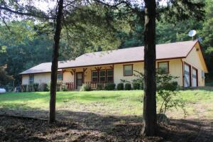 Country Living Only 9 Miles from Harrison!! 4.58 Acres with comfortable & surprisingly roomy home almost hidden behind the trees. Home includes 3 bedrooms, 2 baths, nice den with brick hearth and wood stove, newer Rheem heat/air units & water heater, 10x10 bonus room off attached double garage and nice stairway to floored attic that runs entire length of house for storage or check the possibility of making it additional living space. Outside you'll find a 16x26 ft garage/shop building, fenced garden, extra nice green house and wood frame chicken coop. Located in Bergman Schools, county road dead ends just past this property, the famed small mouth bass Crooked Creek is nearby and Bull Shoals Lake is less than 30 minutes away. Make Your Appointment & See it Today !!