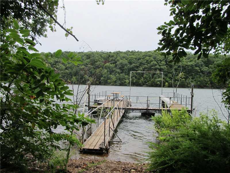 3 Lake front acres with well and septic in place. Small cabin a bonus. Great building spots to choose from. Single owner boat dock with swim deck. Nieghborhood launch next door. Private quiet spot. Your own pice of paradise on Beaver Lake. Call for a,private showing today.