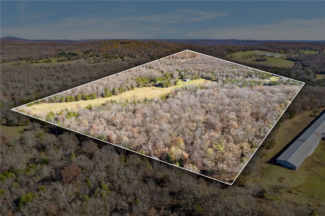 Discover the perfect blend of nature and convenience with this stunning +/- 80-acre property just outside Elkins! This mostly wooded property features a large barn with electricity and a well next to it, Kroger Branch Creek flowing through the property, and a mix of open fields and dense wooded areas. This property offers an ideal setting to build your dream home, start a farm, or simply enjoy peaceful, rural living - all just 7 minutes from Fayetteville. With all utilities (except sewer) available on site, this land is ready for your vision. Don't miss this opportunity to own a private retreat with endless possibilities.