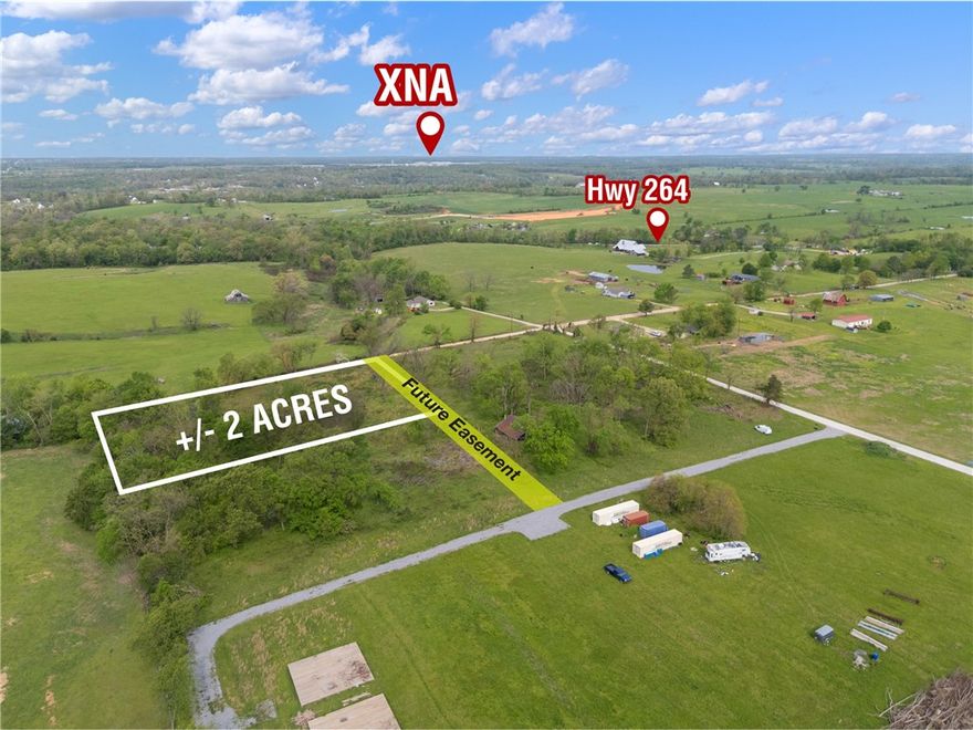 +/- 2 acres of land available just outside city limits, offering the perfect opportunity to build your dream
home and enjoy peaceful country living. This prime location is less than 9 minutes from XNA, only 5 minutes from The Creeks Golf Course, and situated just a half mile from Highway 264, providing convenient access to nearby amenities. Located within the highly sought-after Bentonville School District, this property combines rural charm with top-tier educational opportunities. Electric service is available at the street, while a septic system and water well will be needed. A future easement to be added for easy access to the property.