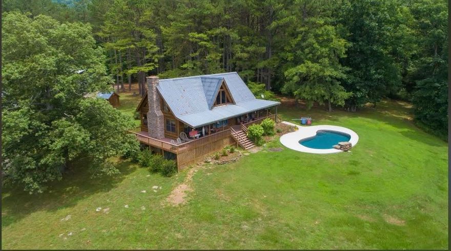 Welcome to Baldwin Creek Camp, spectacular getaway or place to call home. Primary residence, bunk house, & secondary home, all located in the Ozark Mountains on 240 pristine acres with views for miles. Joins large National Forest for 1 1/4 miles, 2 stocked ponds, w/year-around Baldwin Creek running through property. Approx 40open/200wooded rolling acres makes for a hunter’s paradise or just plenty of room to explore the outdoors. Fabulous 1600sqft m/l 1br/1ba+loft main cabin with open gathering area, cozy wood burning fireplace, both covered & enclosed porches overlooking scenic grounds. Outside enjoy the heated pool, firepit, handy outdoor shower. 55x30 shop building w/unique bunkhouse/hang out and bath. additional 20x30 enclosed garage, 2drilled well, ozarks go internet. 1120sqft m/l 2br/1ba secondary home w/large covered porch. It is rare to find this abundance of features in a single property. So many possibilities! A written description falls short of experiencing it in person, come see for yourself!