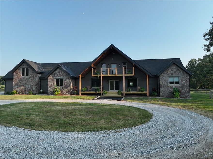 This beautiful Estate with its class, warmth & charm offers rural living with a wonderful balance of comfort & convenience and within easy reach of City Lights! Live in total luxury while the great outdoors awaits your creative brand whether it be a working farm or a recreational playground or why not both?  Tranquil views inspire joy & positive energy. Floor plan designed for personal privacy  with multiple gathering spaces for socializing with family & friends!  Home features Anderson windows, walk-in pantry, 778 sf garage space, Dual fuel electric/gas, slate/stone flooring in the entryway, Architectural shingle and standing seam metal roof, James Hardie Wood Plank Siding, Shop has loft storage w/electric, Backyard is farm/ranch yard fencing, underground 500 gal propane tank.  Private yet less than 2 miles to Gravette and  approx 10 miles to Bentonville & beyond in literal minutes!