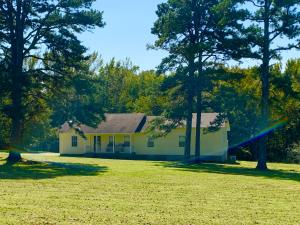 Located on 3 beautiful acres just north of Clarksville above Lake Ludwig is home to an immaculate 5BR/4BA country property w/ large pine trees that frame the home and a stunning sun deck that overlooks a wooded setting. The condition is like-new: laminated flooring (2017) and new hvac (2016). 2 master suites - one w/ a WIC, jetted tub, & bay window. A wood burning FP centers the living room and is open to the dining area and kitchen featuring a breakfast bar and pantry. This is a must see rare opportunity to own a 5BR home!! 1 year home warranty included.