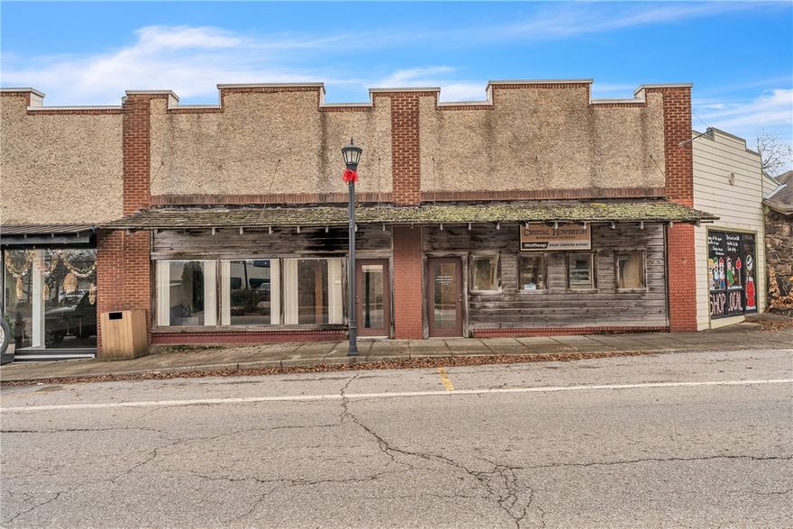 Welcome to a versatile commercial space offering charm, functionality, and exceptional visibility. Featuring gorgeous original woodwork, soaring ceilings, and expansive windows overlooking the vibrant town square, this property provides a bright and inspiring atmosphere for both employees and clients.
The flexible floor plan accommodates multiple office setups, including a spacious main office with a stylish loft—perfect for additional workspace or storage. Beautiful hardwood floors flow throughout, enhancing the warm and professional aesthetic. A convenient kitchenette adds daily practicality, making the space well-suited for a wide range of business uses. Whether you’re seeking a new headquarters, boutique studio, or co-working environment, this property delivers unmatched character and convenience in a prime location.