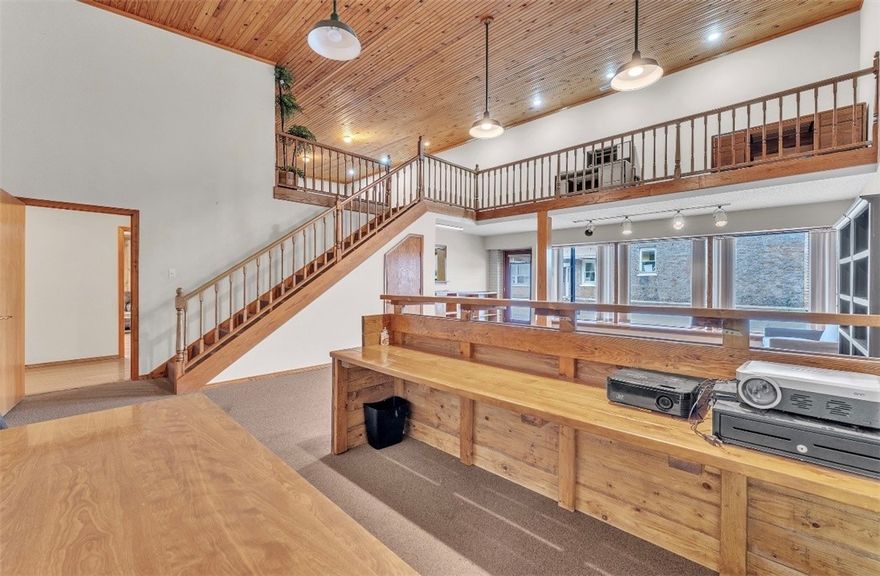 Welcome to a versatile commercial space offering charm, functionality, and exceptional visibility. Featuring gorgeous original woodwork, soaring ceilings, and expansive windows overlooking the vibrant town square, this property provides a bright and inspiring atmosphere for both employees and clients.
The flexible floor plan accommodates multiple office setups, including a spacious main office with a stylish loft—perfect for additional workspace or storage. Beautiful hardwood floors flow throughout, enhancing the warm and professional aesthetic. A convenient kitchenette adds daily practicality, making the space well-suited for a wide range of business uses. Whether you’re seeking a new headquarters, boutique studio, or co-working environment, this property delivers unmatched character and convenience in a prime location.
