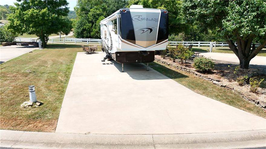 Wrap yourself in the lake breeze with this gorgeously landscaped RV lot on Table Rock Lake. Back in lot is extra wide and offers plenty of parking space and even further opportunities for development should you decide to expand. Close proximity to the bath house, pool and activity center. Full hook ups and only 30 minutes drive from Branson.  Summers were made for the Ozark Mountains.