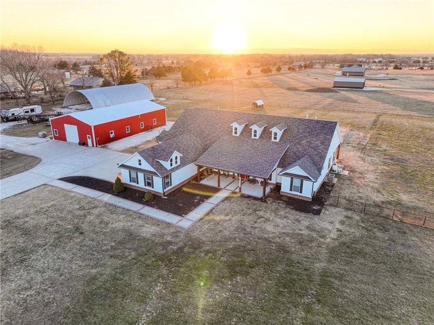 Stunning 4-bed, 3.5-bath home on 4.46 acres, featuring a massive master suite with a clawfoot tub, tile shower, & double walk-in closets. The open-concept living area boasts floor-to-ceiling windows & a gas log fireplace in the living room & a kitchen featuring an oversized island, double fridge, Wolf gas range & espresso machine, separate wet bar with icemaker & beverage fridge, & trash compactor. Enjoy outdoor living with a 5,000 sq ft quonset hut with RV hookups, a 3,000 sq ft heated shop with a separate heated & cooled office area, storage loft, & security system, a 9-ft deep pool (new liner in 2023), & a hottub. 2 of the 3 additional bedrooms has an attached bath. Additional highlights include a mudroom with utility sink & 2 water heaters, heated & cooled garage, 1,000-gallon buried & owned propane tank, Generac backup generator, double washer/dryer with folding area, separate office, & so much more! Located directly across from Pea Ridge Military Park for added charm & convenience. So many extras to explore!