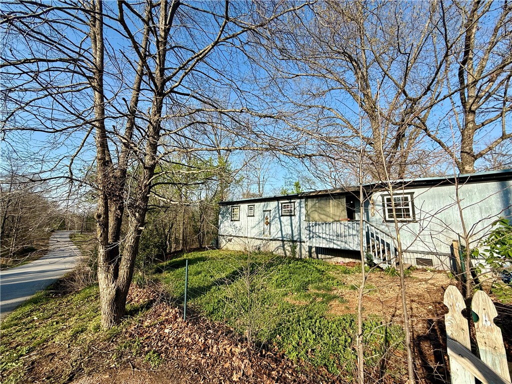 Great location. just minutes from I49 and Lake Avalon. Split floor plan with open living area in the middle. Nestled in the trees with a covered deck and large backyard.