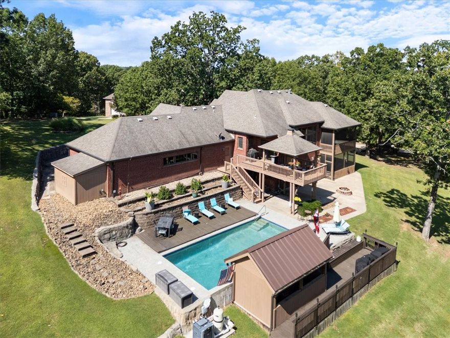 ~Motivated sellers~ New paint in entry, dining room and downstairs and new carpet! Come check out this beautiful, secluded, well maintained home in a quiet neighborhood just minutes to Beaver Lake. The large gourmet kitchens with tons of storage flows openly to the living room. The primary is situated on the main floor and shares a fireplace with the bath. Primary also has a large screened in private deck. On the lower level you will find 2 additional bedrooms, an office with a closet, a second living area with a fireplace, game room and kitchenette/bar area. Walk out of the basement to the gorgeous inground heated pool with a swim up bar. This house is an entertainer's dream! The HOA does have a community boat dock on Beaver Lake, that is available for owner and guest use. Winter views of Beaver Lake. Investors? This home can be used as a STR, however, no watercraft can be parked in the driveway or on the street. Only 10 minutes to downtown Rogers, 25 minutes to Walmart Home office and a 45 minute drive to Eureka.