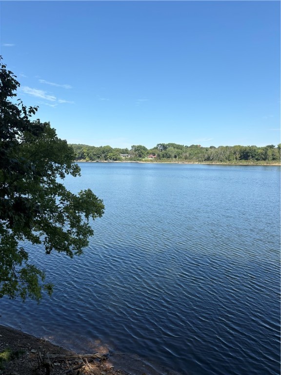 Invest in this fabulous lakefront 6+ acres in the coveted Barzel Point subdivision. Easy paved road access back to Rogers for shopping and fun, and across the lake from War Eagle Marina. Beautiful houses abound in this neighborhood, and access to a concrete boat ramp is at the end of Barzel Point Rd. There is plenty of room for a new home up near the road, and county maps show the property line almost in the water. The neighbors to the west have cut trees between their house and the lake; and opened up a really sweet N/NW view. Ozark forest and Beaver Lake Beauty in one great package!