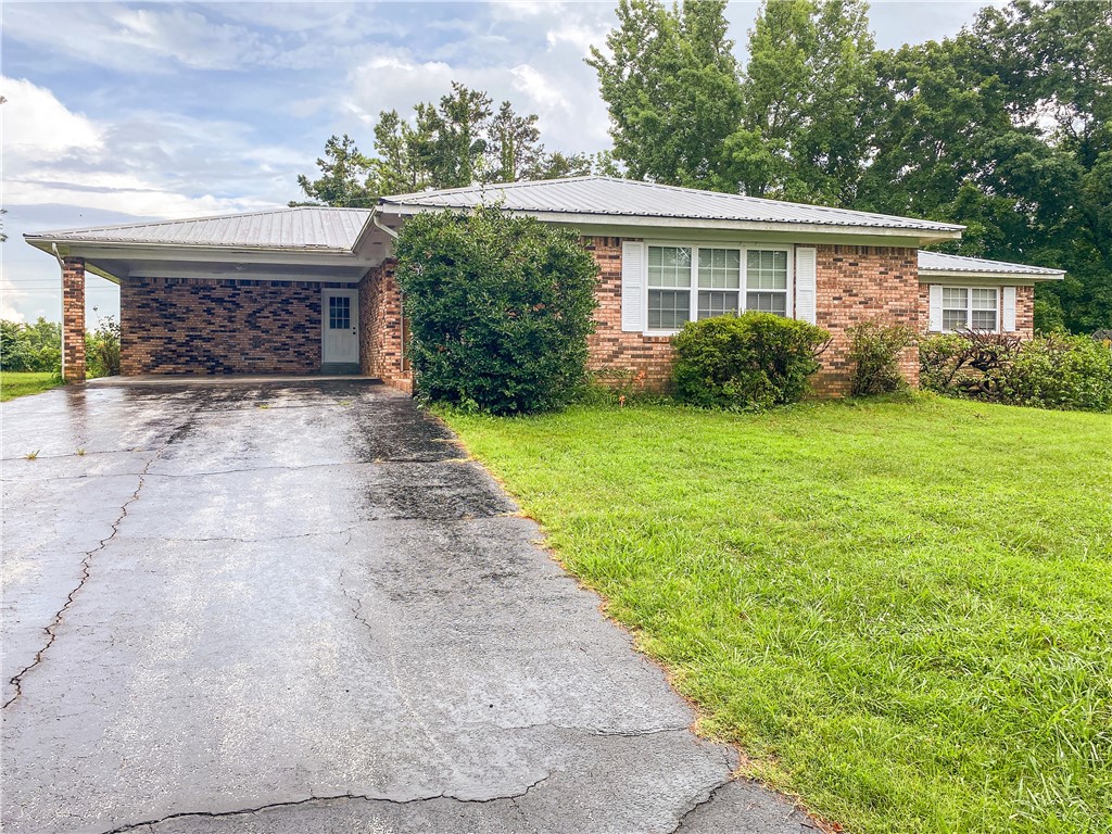 4336 SF 4 BR 3 BATH house with basement located in the city limits on a large 1.14 acre lot. Located on the edge of the city limits but feels like it is in the country. Features of the home include a very large living room area, nice kitchen with stainless appliance, mother-in-law quarters in the walk out basement, washer/dryer hook up on both main floor and basement, office/study, covered deck off the master bedroom, covered patio off the kitchen, basement garage, basement safe room with concrete top, attached covered carport on the side of main level, natural gas HVAC and option to convert the house from septic to Harrison sewer. 4th bedroom in basement is very large and could be converted to den, recreational area or man cave.