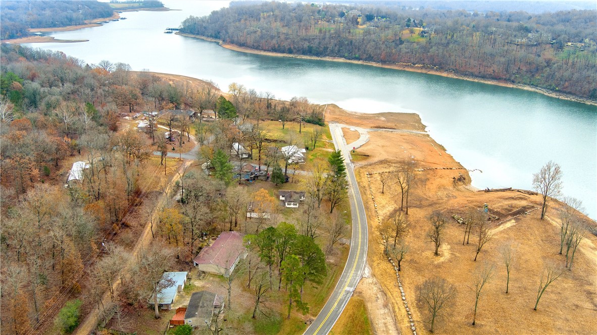 Million-dollar lakeview from both homes. Shared utilities, cannot sell separately. Small house 960SF 3BR/1BA, Large house is 2432SF, 4BR/3BA. Great rental. Great condition, ready to move in. Sold AS-IS. Swimming, fishing, boating across street.