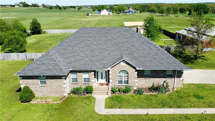 Beautiful brick home on 5.7 acres, minutes from town! Enter the estate on the concrete drive that will direct you to the shop or the home while passing by several of the trees recently planted, varieties include pecan, apple, peach, & plum. 3 bds, 3.5 ba, 3144sf-each bedroom has a bath! Large office with built-ins, a music/game room or 2nd office, additional living area or 4th bedroom. Semi-open floor plan, split bedrooms. Kitchen has granite, island workspace, gas range & double wall ovens for the cook in the family. Huge pantry with access directly from garage. Sewing room off utility. Bedrooms are oversized w/ walk in closets. Hand scraped hardwood/tile flooring. 60x60 shop w/ 2 overhead doors, 20x25 lean-to and 1200sf 1 bedroom/1bath apartment w/ utility area, LR, kitchen. In-ground saltwater pool/vinyl liner in the privacy fenced yard. Brick 10x16 storm shelter w/ electric. A short drive to everything-17 mi from U of A, 9 mi from 412/shopping/bank in Siloam Springs, 15 mi to I49. Pool-Vinyl liner-3yr/cover-1yr