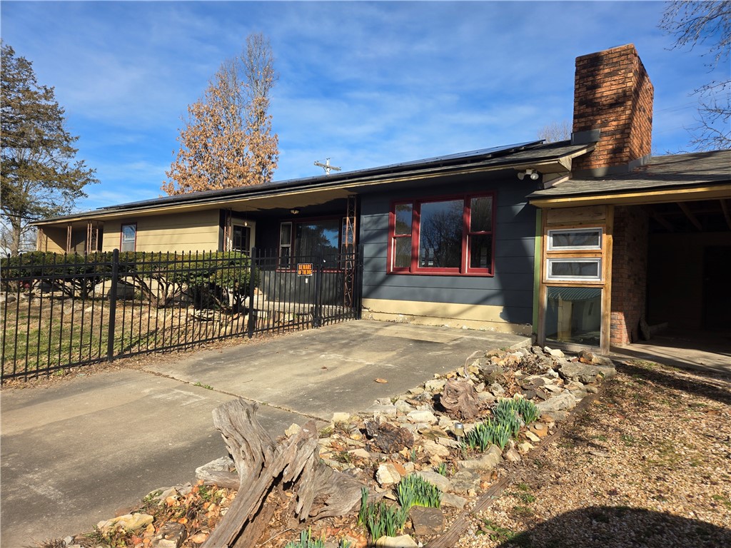 Ranch-style home with a patio area, roof mounted s