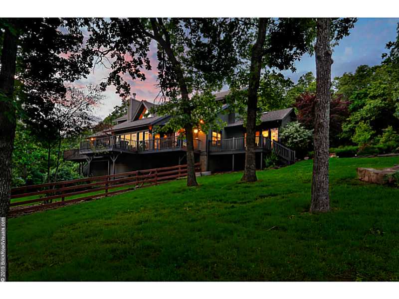 The ultimate dream! Designed by architect Albert Skiles. Park-like setting offers panoramic views. Private secluded home in admired in East Fayetteville area. 3.13 wooded acres at the end of the cul-de-sac. Features open floor plan, granite counter tops,fireplace, huge deck and hot tub. Wall of windows inviting nature in, soaring ceilings, hardwoods, plantation shutters. Detached workshop/garage. Appended architectural design and a new roof!