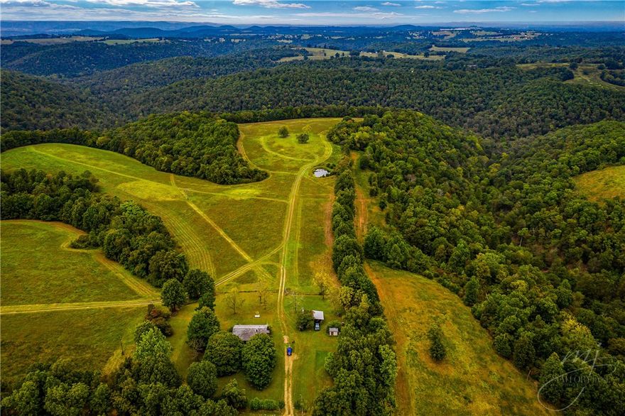 This 550 acres has it all, pasture, timber, deer and turkey, wet weather spring, and great views from one of the highest points in boone county. 430' well on the property with rural water at the county road at the corner of the yard. Multiple access points from the county road. South 80 acres has been surveyed. Just 2 miles to bergman school. Seller will not divide.