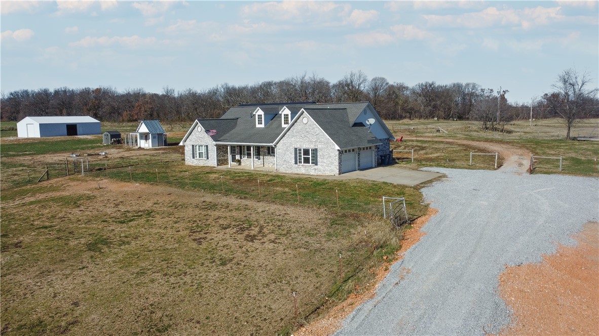 Nestled in the serene countryside of Gravette off Mount Olive Road, this charming 5.42-acre property offers a peaceful retreat perfect for a homestead or farm located on paved road. The well-maintained 2,093 sq. ft. home features 3 spacious bedrooms and 2 full bathrooms, providing ample room for family living. Outside, you'll find a brand-new 40x62 shop, ideal for a variety of uses, along with a 30x50 barn equipped with 4 custom 12x12 stalls for your livestock. The property is cross-fenced with a run-in shelter, ready for horses, and also includes a custom-built chicken coop. Ready for its new owners to move in and make it their own!
