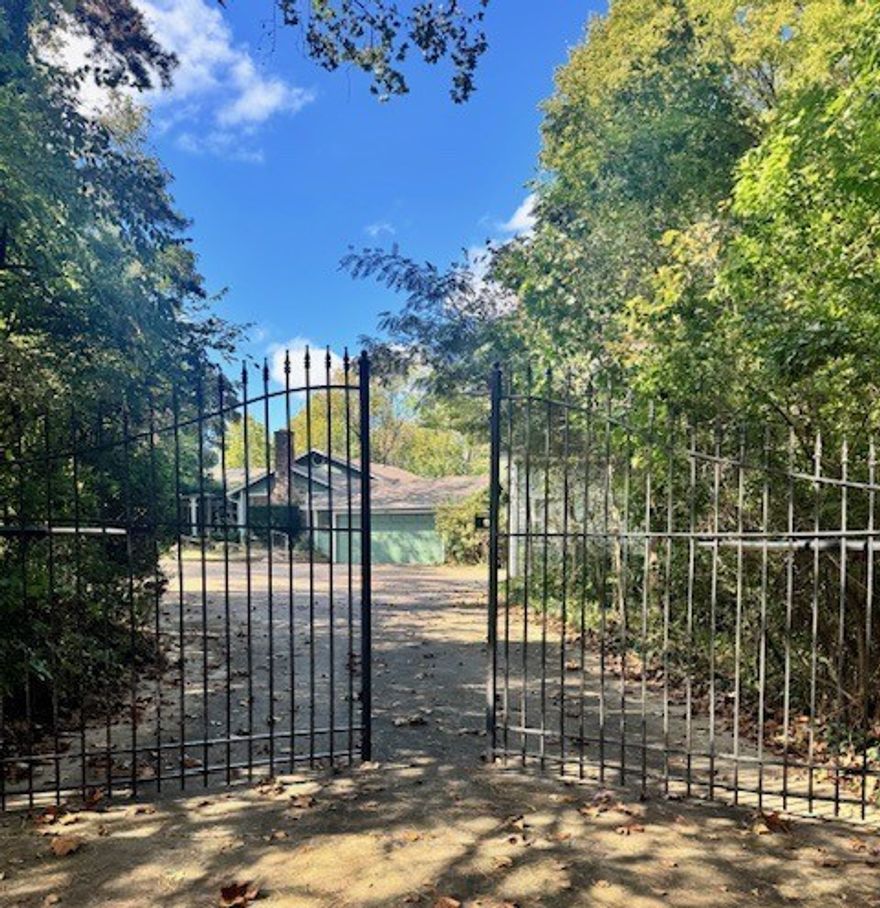 Discover a peaceful retreat on 2.5 acres in East Fayetteville. Affectionately named “Tall Trees” by its owners, this property offers the charm of a country cottage with the elegance of an English-garden setting. Originally constructed in the 1930s and thoughtfully updated over the years, the home blends timeless character with modern comforts.

Step inside to a warm family room featuring an original stone fireplace, complemented by white oak ceilings and multiple areas for gathering, entertaining, or quiet relaxation. The home overlooks Mud Creek, with waterfalls visible after a short trail walk through the wooded property.

The detached garage includes an upstairs living area, perfect for guest quarters, creative pursuits, or hobbies. All just minutes from schools, shopping, and Fayetteville’s extensive trail system, this property offers rare privacy and convenience in one.