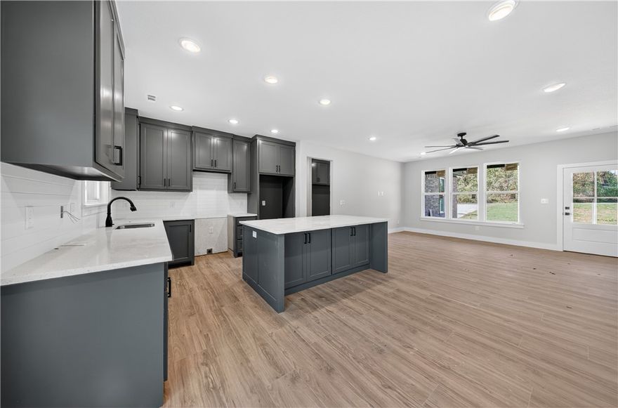 Welcome To Your Next Home. Step Inside To A Bright, Open Layout Where The Kitchen With Island And Pantry Flows Into A Cozy Living Area Perfect For Gatherings. The Split Bedroom Design Offers Privacy With A Peaceful Primary Suite Away From Two Extra Bedrooms And A Full Bath. Open The Back Door To A Deck And Usable Yard Ready For Morning Coffee Or Relaxing Evenings. Minutes From The Popular Back 40 And Little Sugar Trails, You’ll Enjoy Biking Or Walking Right From Home. Bella Vista Lake Trail And The Razorback Greenway Connect You To Bentonville And Beyond. Close To Fishing, Boating, Hiking, And A Short Drive To Downtown Bentonville’s Shops, Art, And Dining. This Home Blends Comfort, Style, And The Outdoor NWA Lifestyle. Move In And Make It Yours Today!
