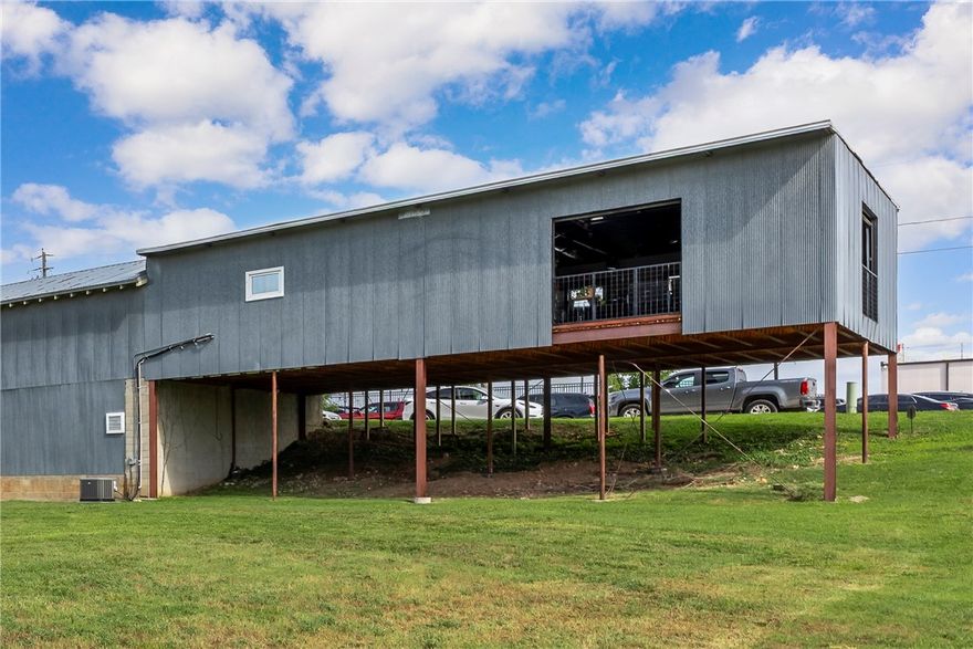 The space is located across from The Railyard and adjacent to the Razorback Greenway bike trail, offering excellent visibility and accessibility. The current build-out could be used for a yoga and spin studio, retail space, office space, exhibit area and has two large glass garage doors, a modern black ceiling with upgraded lighting, and two restrooms. The open floorplan allows for flexible uses, along with the Zoning of T5.2, this location supports a wide range of commercial uses. Showings will be scheduled once the current tenant has vacated.