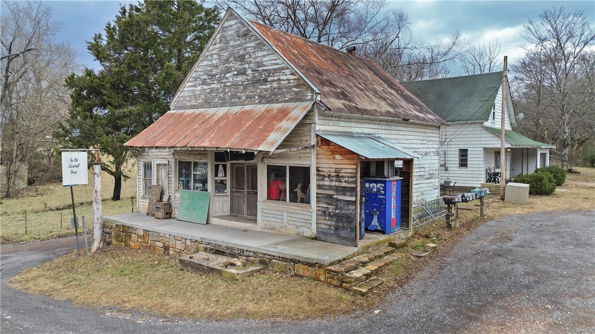 Turnkey business opportunity near the Buffalo National River in Snowball! The Old Snowball House, a 1,302 sq ft, 3-bedroom, 2-bath home, was built in the early 1900s and fully remodeled in 2018 with updated plumbing, electrical, insulation, zoned central air, dual-fuel heating, and hardwood flooring. Operating as a short-term rental since 2018, it has hosted hundreds of guests and comes fully furnished. Next door, the 1,059 sq ft Snowball General Store, one of the town's last historic buildings, reopened in 2019 and operates seasonally on Saturdays. The sale includes in-stock inventory, a self-vending ice machine, and space for future development where a weaning house once stood. This business also hosts the annual Snowball Adventure Race and includes social media accounts, a website, and vendor connections to ensure a smooth transition. Don’t miss this chance to own a thriving business and a piece of Snowball history!