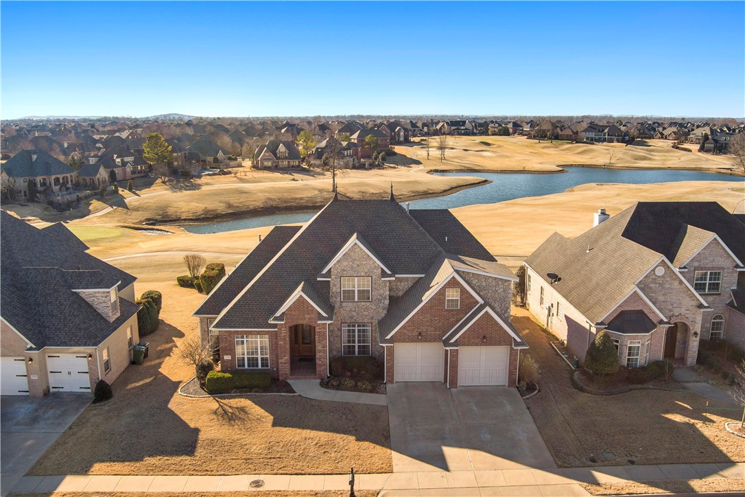AMAZING views and AWESOME location. This 4 bedroom 3 1/2 bath custom home is situated on Shadow Valleys first class golf course with sparkling water views. This home boast a dedicated home office, 2 living spaces, formal dining, and an eat in kitchen with wet bar. Your master bath is fully remodeled and sure to please! 3 spacious bedrooms, 2 full bathrooms with a bonus room complete the second level. This home has plenty of upgrades and trend right finishes that will make you feel right at home. All appliances convey with acceptable offer. This home is waiting for you. Bentonville school district.