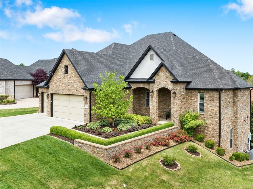 Set in the desirable gated community of Shadow Valley, this home boasts 5 bedrooms, 4.5 bathrooms, an office, walkout basement with 4,590sqft of luxury living space. This home welcomes you with large windows, and open floor plan that is flooded with natural light. The chef's kitchen offers a large island, stainless steel appliances, double ovens, wine fridge, and gas cooktop. The kitchen flows into the dining room, family room, and outdoor covered deck, creating a warm and open atmosphere. The primary bedroom is located on the main floor and offers a luxurious ensuite bathroom and two generous walk-in closets. A second bedroom with ensuite is also on the main floor. The downstairs offers 3 bedrooms, 2 bathrooms, second living space with kitchenette, and access to the backyard and covered patio. In addition to racquet membership that conveys, residents have access to golf, community pool, playgrounds, and community events. Situated in the Bentonville school district, and is close to dining and shopping experiences.