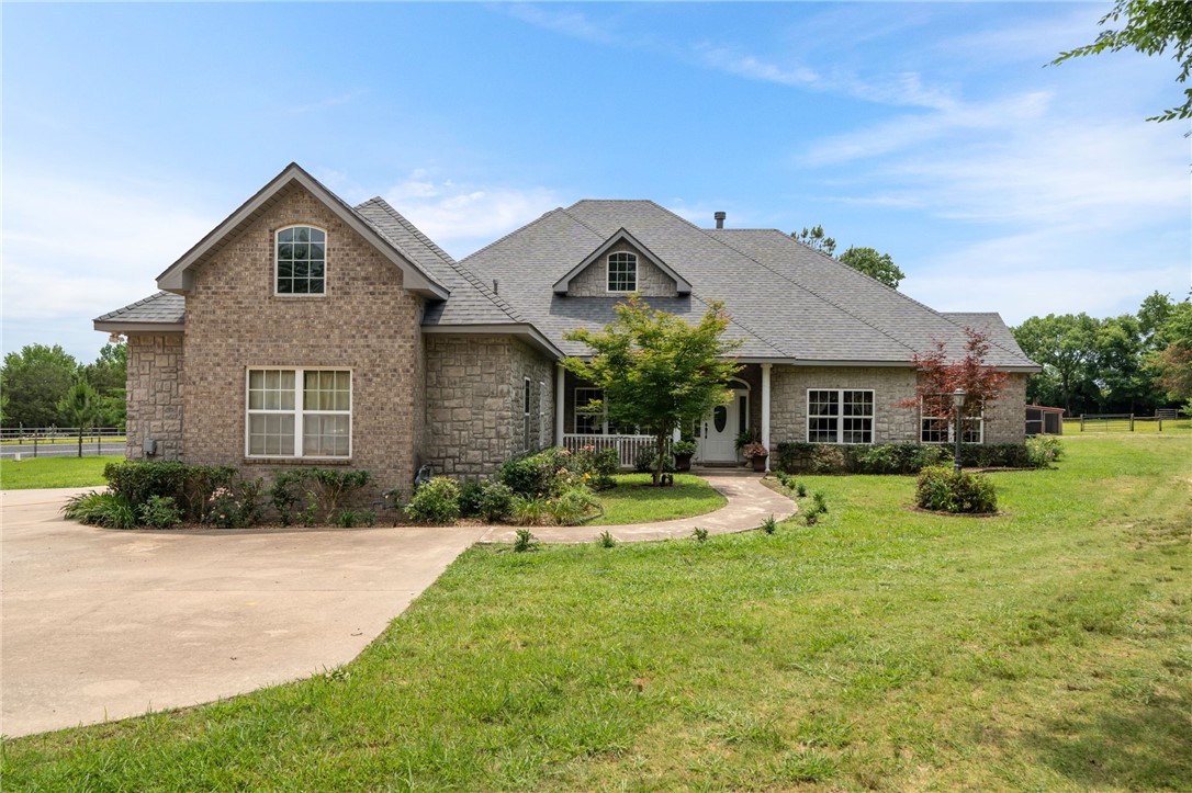 Welcome to your dream country retreat! This stunning one-owner custom-built home offers 2,350 square feet of beautifully designed living space, perfectly situated on 8.94 acres of pristine, fenced and cross-fenced land. Step inside to find tall ceilings, gorgeous travertine tile, and a floor-to-ceiling wood-burning rock fireplace that anchors the main living area. This property is a true horse loverās paradise, complete with a properly constructed shale-floor arena, 3-stall barn, feed building, and a truly amazing chicken coop. Enjoy a peaceful, gated setting with a large pond, mature trees, and plenty of room for animals, gardening, and entertaining. Additional features include a gigantic laundry room with large windows, utility sink, and abundant cabinetry, covered RV parking, and a huge covered back and side porch ideal for relaxing or hosting guests. Whether you're looking to start a hobby farm, enjoy equestrian living, or simply want a tranquil place to call home, this one-of-a-kind property has it all.