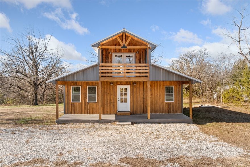 Modern cabin-style home on 2 acres located just minutes from the lake. This 3 bedroom, 2 bathroom property features an open-concept layout, a unique spiral staircase, and all new appliances. Covered front porch and upper balcony offer inviting outdoor living space. Peaceful setting with room to roam while still conveniently accessible. Ideal for full-time living, weekend use, or investment potential. Move-in ready.