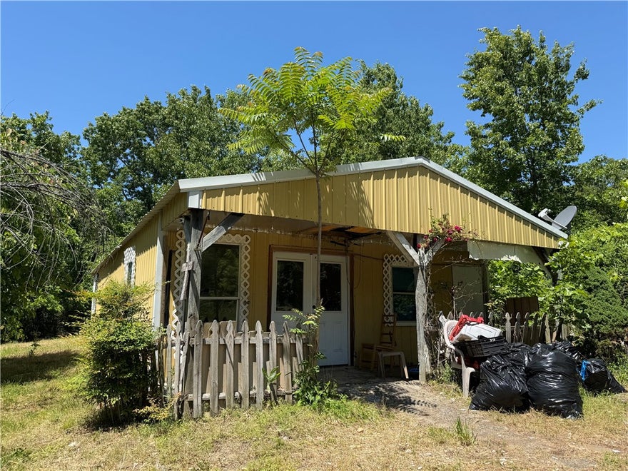 Positioned on a secluded .44-acre lot, this property offers a rare opportunity for an investment project or a private cabin retreat in a prime location, now featuring a freshly graveled driveway for easy access. You are situated just minutes from Bryce's White River Marine and Don Roufa Beaver Lake access ramp, providing immediate entry to the area's best fishing and boating. The structure requires renovation but features a solid footprint for those looking to build equity in a high-demand outdoor corridor.