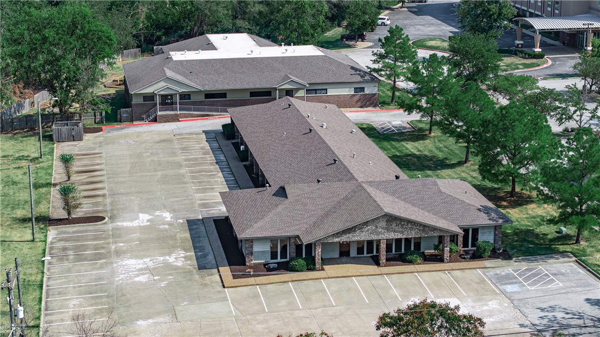 Prime commercial real estate. Two office buildings totaling 18,367 square feet situated on a busting corridor with a 39,000 daily traffic count. The Razorback Greenway is located on the 2.87 acre tract, attracting health-conscious professionals and offering employees an alternative commuting option. Minutes away from the new Walmart campus, Northwest Medical Center, and 1/2 mile from I-49, this property presents an exceptional opportunity for investors or businesses seeking high visibility and a thriving business environment.