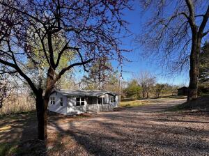 Quaint 2 bed 2 bath home, newly remodeled with a top to bottom overhaul is perfect for a couple or small family. Well finished with quality cabinets, granite counter tops, marble back splash, tile showers, luxury vinyl plank flooring throughout, making this house feel very warm and welcoming. Outdoors you find a low maintenance exterior, covered front porch, back deck, and 2 outbuildings for storage. Located on an all useable 2 acre m/l lot with a country feel, this property is perfect to keep a few small animals and to have a beautiful back yard. Rural water, Ozarks electric with OzarksGo internet. Enjoy out of town living with accessibility to amenities. Approx 30 min to Fayetteville. Call listing agent to schedule a showing today!