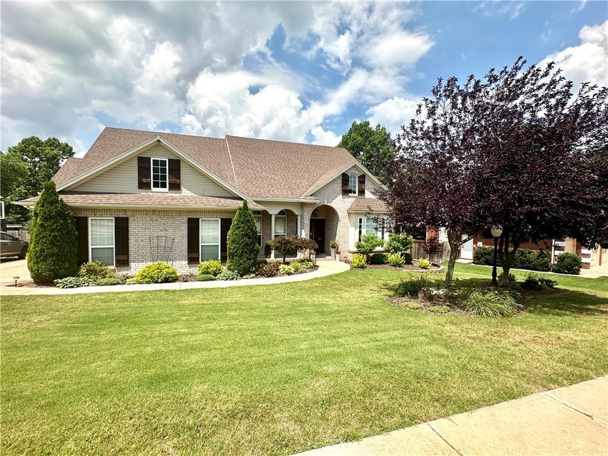 This gorgeous home has been custom redesigned with exquisite high-end details and luxurious
amenities. Located in one of East Fayetteville's most sought after neighborhoods.
The open floor plan make it perfect for entertaining. All 4BR are located on
main level with game room or in-law suite upstairs along with kitchenette & full bath.
The kitchen is equipped with all high-end stainless steel Jenn-Air appliances, verser cabinets with soft close drawers and doors, warming drawer, two dishwashers, beverage cooler, and ice maker. Living area
has customized shelving on either side of the wood burning fireplace to accommodate
flat screen TV. The elegant master bath includes Carrara marble countertops and custom glass tile work
throughout. The large walk-in closet includes pull down hanging rods.  Outdoor space contains a
heated gunite salt water pool with waterfall. Extensive landscape and rock work. Pergola includes
custom rock fireplace, beverage cooler, sink, and gas grill with travertine
countertops.