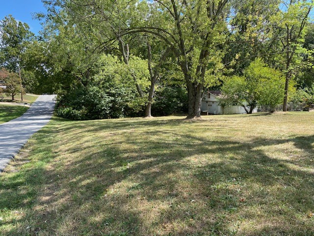 Nice 0.46-acre corner building lot, perfect gentle slope for a walk out lower level. Existing 20' x 24' garage/workshop, concrete floor, double overhead door, (no opener), wood stove. All utilities at street. The electricity in the shop will be disconnected as it is supplied from the former combined house & lot. The County Assessor's office split the lot into 2 parcels. Nice established neighborhood, land goes to bottom of ravine.