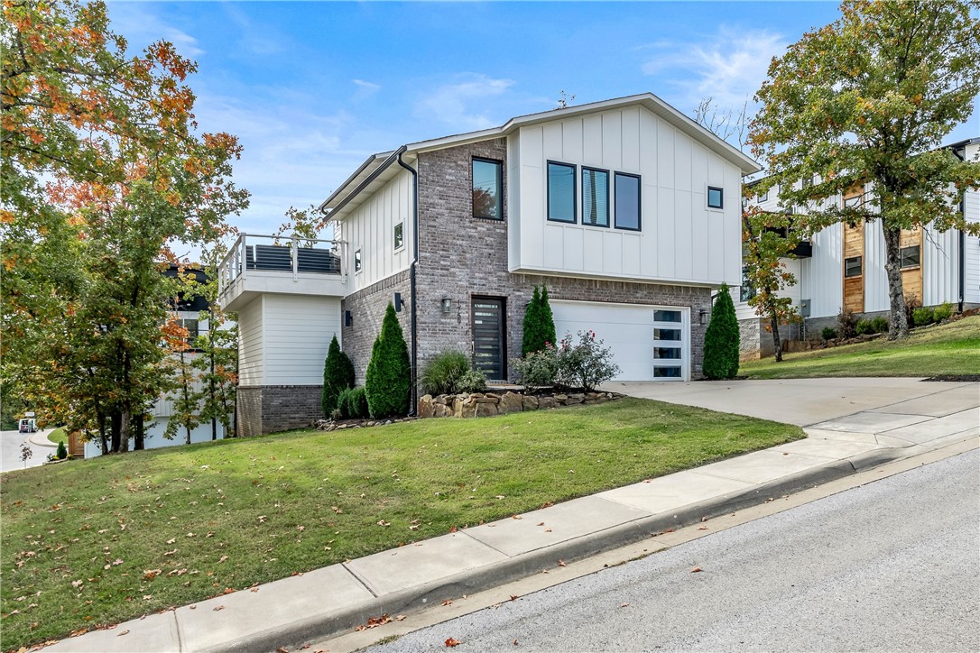 A stunning contemporary home that offers the tranquility of a treehouse retreat yet just a few minutes from all that downtown Fayetteville and Dickson Street has to offer. Embrace the blend of nature and urban convenience, where a wooded walking trail is just steps from your doorstep. Prepare to entertain in style with an amazing, expansive entertaining space that seamlessly connects indoor and outdoor living. High end touches throughout which includes gorgeous quartz and granite countertops, appliances, wine fridge, tankless water heater and smart technology including front door, nest, refrigerator, w/d and garage door. Home has been well cared for and feels brand new. City of Fayetteville has approved the highly sought after Conditional Use Permit for a short-term rental and will convey with property, if desired. Mt. Sequoya Woods Trail is just steps from the house which has a beautiful 1.25 loop through the woods. The option to purchase home fully furnished will be considered.