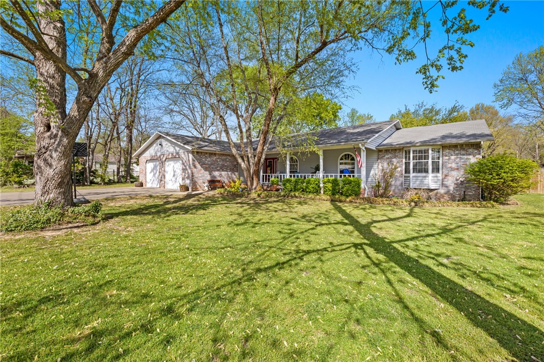 Charming One-owner home in the heart of Prairie Grove! Nestled among mature trees on a spacious double lot, this well maintained home offers the perfect blend of comfort, convenience and potential. With a new privacy fence in 2023, new HVAC and hot water heater in 2022, this home is move in ready! Designed for peace of mind, it features multiple gas appliances and a cozy wood burning fireplace, ensuring warmth and hot water even during power outages. In addition to the expansive kitchen and living area this home includes a dedicated office space, offering flexibility for remote work or hobbies. The inviting front porch and screened in back patio that overlooks the backyard is ideal for relaxing and entertaining! With a double lot, there is plenty of room to build a shop or expand as needed! Lots of space and extras, come and see it!
