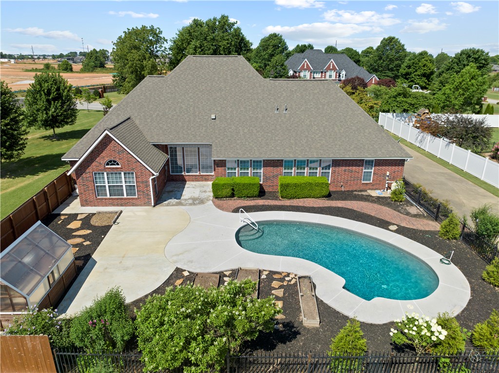 This custom built home sits on .75 acres in coveted Laurel Crossing Subdivision and is a Must See! Located in the middle of NW Arkansas, it's close to the Greenway trails, the Amp, Shopping, great dining & more. The backyard is the private oasis you have been waiting for, with its in-ground salt water pool & Yoder built greenhouse. With so many extras added to this home, you will want to check out the attached Highlights list for all the details. you are welcomed by its circle drive & beautiful front entry, leading to 4 bdrms, 3.5 baths, 2 living Rms, a formal dining Rm & 2 designated offices- One of which is adjacent to the garage for privacy. The newly updated Chef's kitchen has stunning quartzite counter tops, a new professional Kitchenaide range, & an ice maker. Other extras include: Huge Primary bdrm closets, RV & hot tub hook-ups, New Hardwood flooring & carpet, New paint, irrigation, surround sound, central vac, New HVAC units, a huge unfinished attic space above the garage reachable by stairs, & more.
