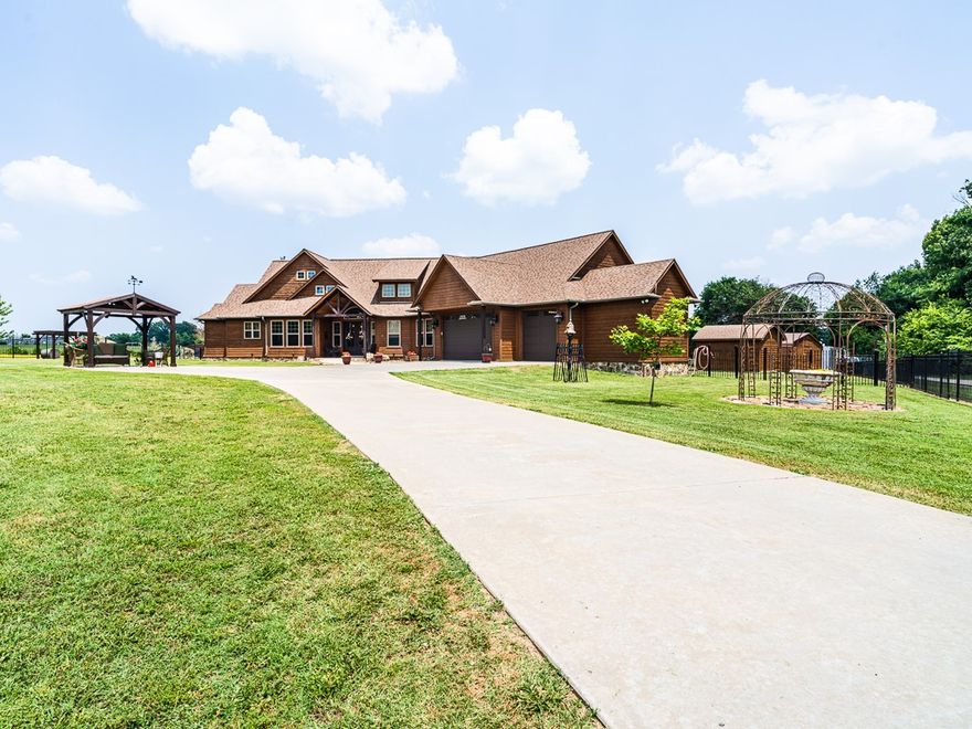 Beautiful Gentleman's Farm! Unique Lodge style cedar home, large open floor plan with split bedrooms, iron fencing on 4.39 acres, well maintained, outbuildings for horses and feed/tack storage, 3 car garage, interior wood accents, 8 foot tall interior doors, knotty alder cabinets, plantation shutters, all granite counters, 3 bathrooms, 3 bedrooms, office, two fireplaces, 2 sun porches, covered porch, deck and patio, 2 gazebos, fire pit, 2 HVAC systems, attic storage with stairs, large cedar seasonal closet, hardwood floors, ten foot ceilings throughout, cathedral family room. porch swing,  man cave store room, private,  concrete driveway, in ground storm cellar,  super insulated, great location on paved road, city water, natural gas, cable access, custom built, great family home with ample space for outside enjoyment, Brand new roof installed in August, 2023. HVAC vented into both enclosed porches.