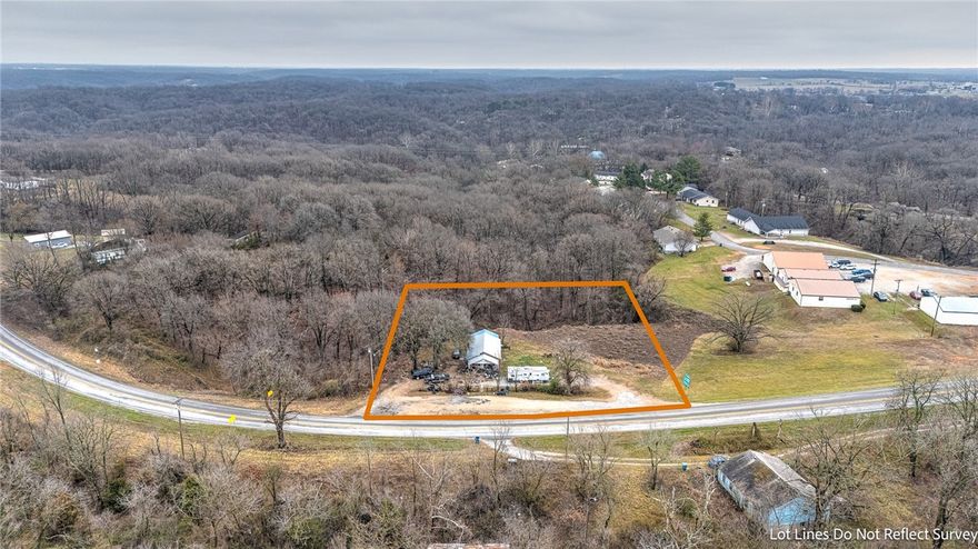 Prime 1-acre commercial opportunity just one mile north of downtown Gravette with 213 feet of high-visibility Hwy 59 frontage. Traffic counts up to 10,000 vehicles per day provide excellent exposure. Located outside city limits, the property currently has no zoning restrictions, allowing flexibility for a convenience store, warehouse, supply house, office building, restaurant, medical office, and more. Gently sloping and development-friendly, the site includes public water and electric on site plus an existing septic system. Currently rural in designation with potential for annexation into the City of Gravette for future growth opportunities. Great investment in a developing corridor.