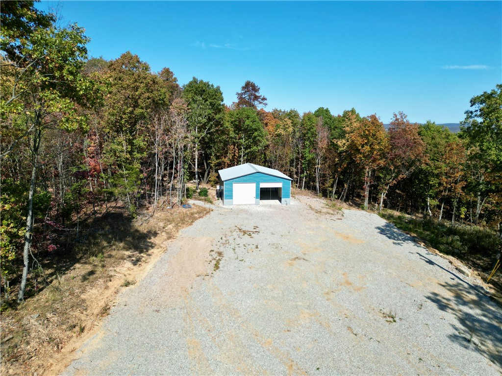 Just under 26 acres of secluded partially wooded acreage with no covenants! Approximately halfway up the hill is a clearing with a 30 x 30 metal shop building. Building is insulated, has electricity, French drains and ample space to park an RV, trailer or other equipment with an electrical connection. Travel further up the hill and find an additional clearing for a potential build site with beautiful views! There are two electric meters, two fiber optic lines and two water meters on the property. Property is located 8 miles south of Wesley and 9 miles east of downtown Elkins.