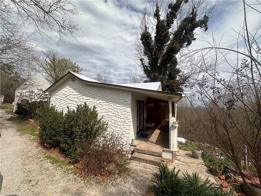 This 2-bed, 2-bath home on 9 acres is perfect for investors or buyers seeking a one-of-a-kind fixer-upper. This unique home offers an office/library, a finished basement with custom tile floors, and a 17ā round bonus roomācomplete with a loft and stunning floor-to-ceiling windows, ideal for a studio or guest suite. Some renovations are underway: new vinyl plank flooring in one bedroom, updated tile and vanity in the main bath and much more. The land is a gardenerās dream with lush foliage, back views, and a level side yard. A partially enclosed breezeway connects the home to the bonus space, and a large garden shed includes its own 18x12 deck for entertaining or potting. Bring your creative vision and make this whimsical property your own!