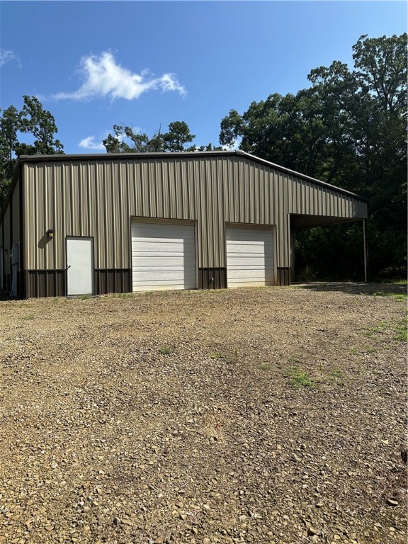Discover this exceptional 8-acre property offering stunning Lakeview vistas, 85% cleared ready for development or recreation and a premium 60x80 insulated metal shop built in 2015. This property is equipped for both work and play, perfect for entrepreneurs, hobbyists or anyone seeking space with serious potential. Shop highlights, double metal walls, 16ft exterior walls, (3)10x10 electric shop doors, (1)12x12 electric shop door, 10 ft electric hydraulic car lift, (5)3x4 windows, (3)personal entry doors, (2)220V electric plugs, Deep utility sink, bathroom with shower, wired for outdoor auxiliary generator, under roof 40x20 RV parking pad with full utility hookups (water, sewer, electric), unimproved well and circle drive for easy access. Excellent site usability and room to build a home. Whether you are looking for a versatile homestead, a private shop setup, or a basecamp near the lake, this property is a rare find with the infrastructure already in place. Don't miss your chance to own this well-appointed acreage!