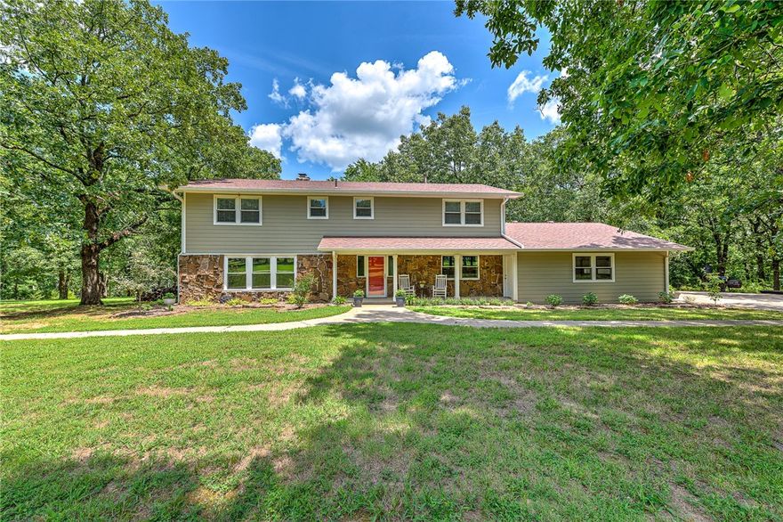 Completely Remodeled Home sitting on 36 Acres just to the west of Prairie Grove.  You will love the privacy of the wooded perimeter and open area plus 2 Ponds in the middle.  There is a wood corral area for Horses and  Large Barn with tack room with loft storage. Inside the home there are wood floors throughout the home except tile in the bathrooms.  There are two living areas plus a sunroom to enjoy the wooded view. The kitchen and formal dinning are loaded with cabinets and counter space. The Master suite comes complete with its own massive rock fireplace and a walk in closet that you will have fun trying to fill up.